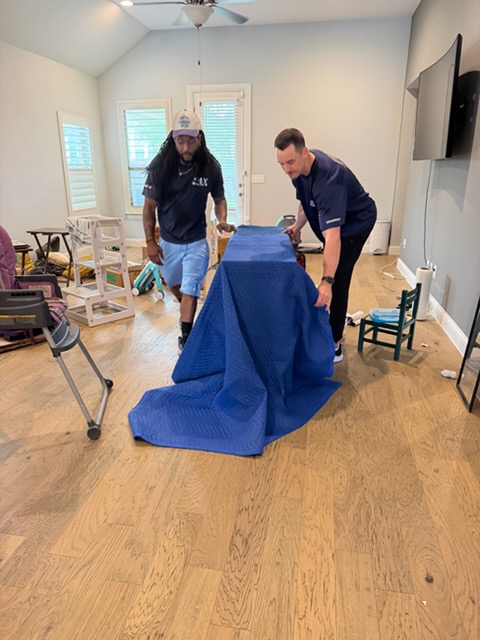 Playhouse Moving crew carefully wrapping furniture for an Austin move