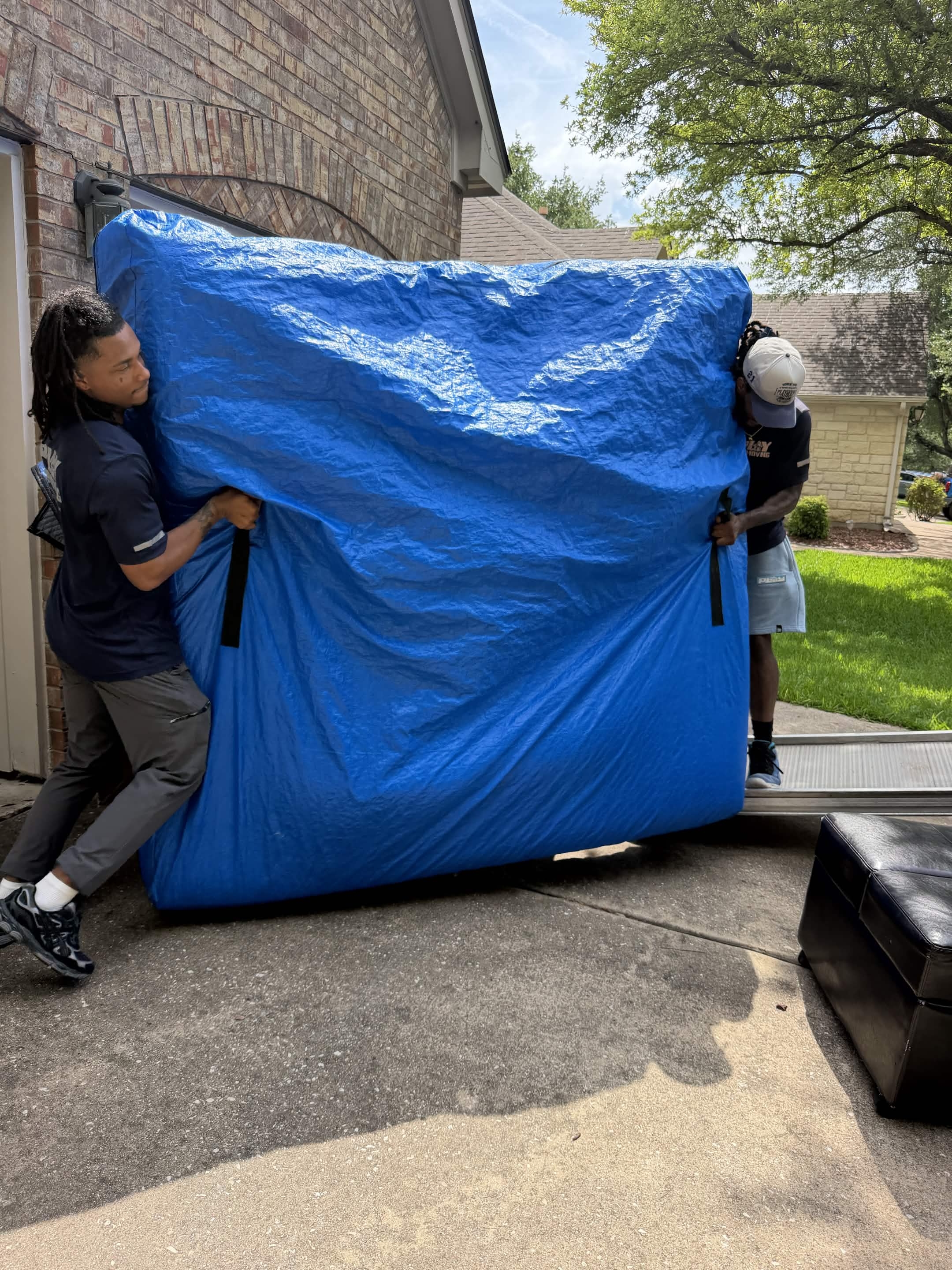 Playhouse Moving crew carefully wrapping furniture before an Austin move
